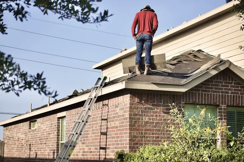 Professional roofer working on a residential roof in Pinnacle Heights Housing